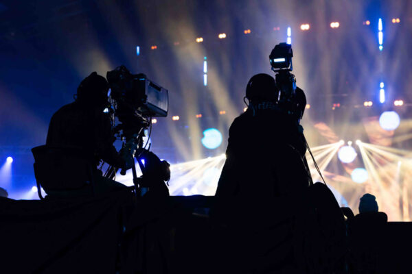 A group of cameramen working during the concert.
